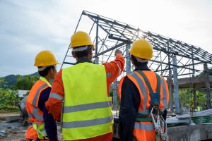 Construction workers wearing safety clothing and discussing on construction site